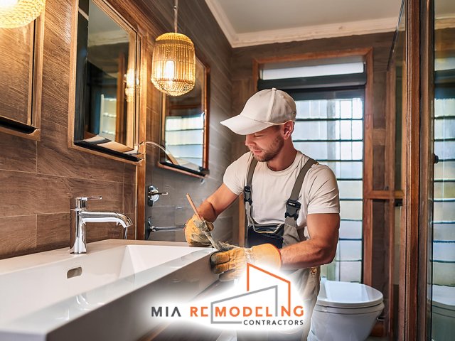 male professional technician working performing expert bathroom renovations remodeling and construction service