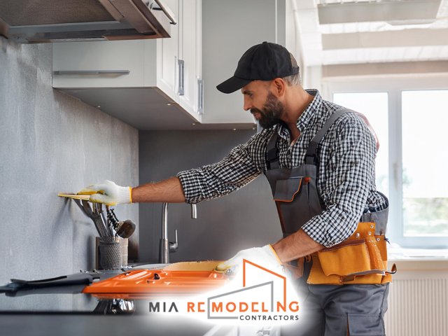 male professional technician working performing expert modern kitchen remodeling and construction service