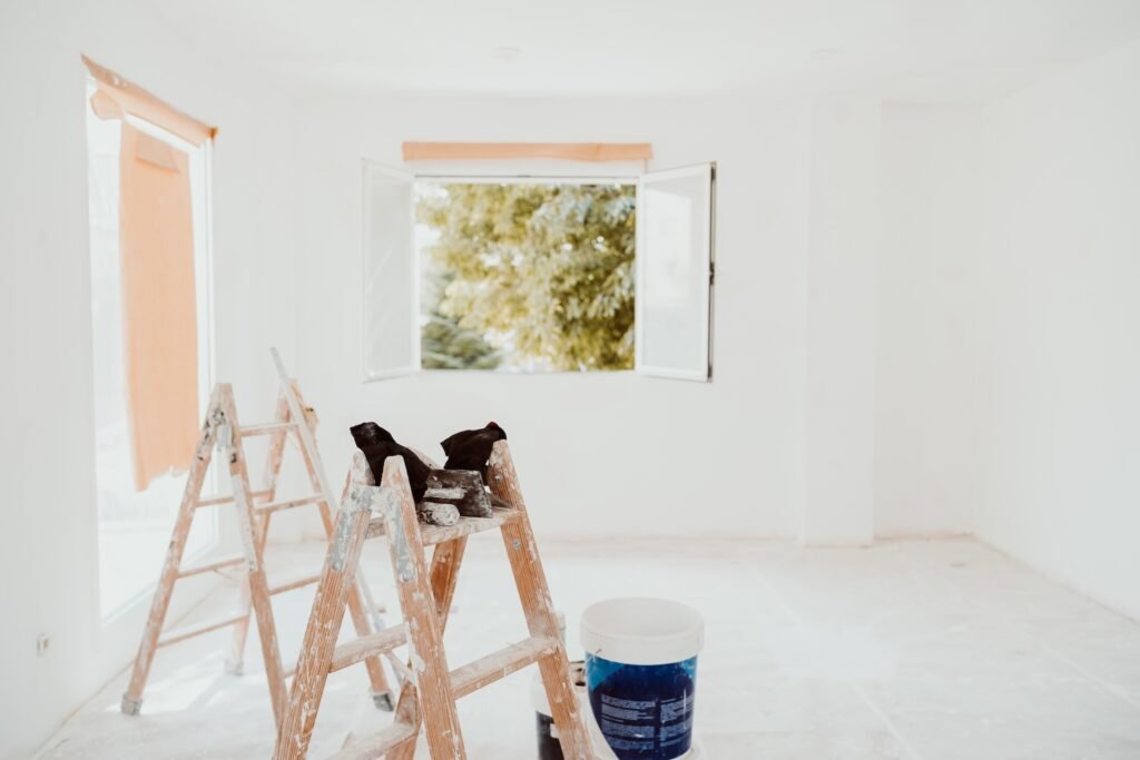 ladders and painter tools on white room at construction site. Painting walls. Home improvement