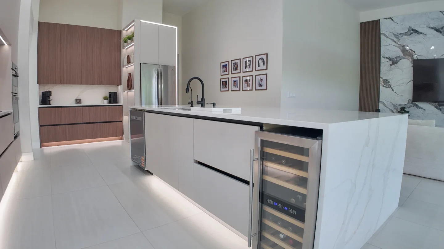 Dark walnut kitchen with a white island in Miami Beach, FL