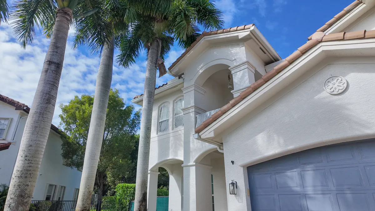 Arched entry and tile roof on a South Florida home finished by MIA Remodeling Contractors