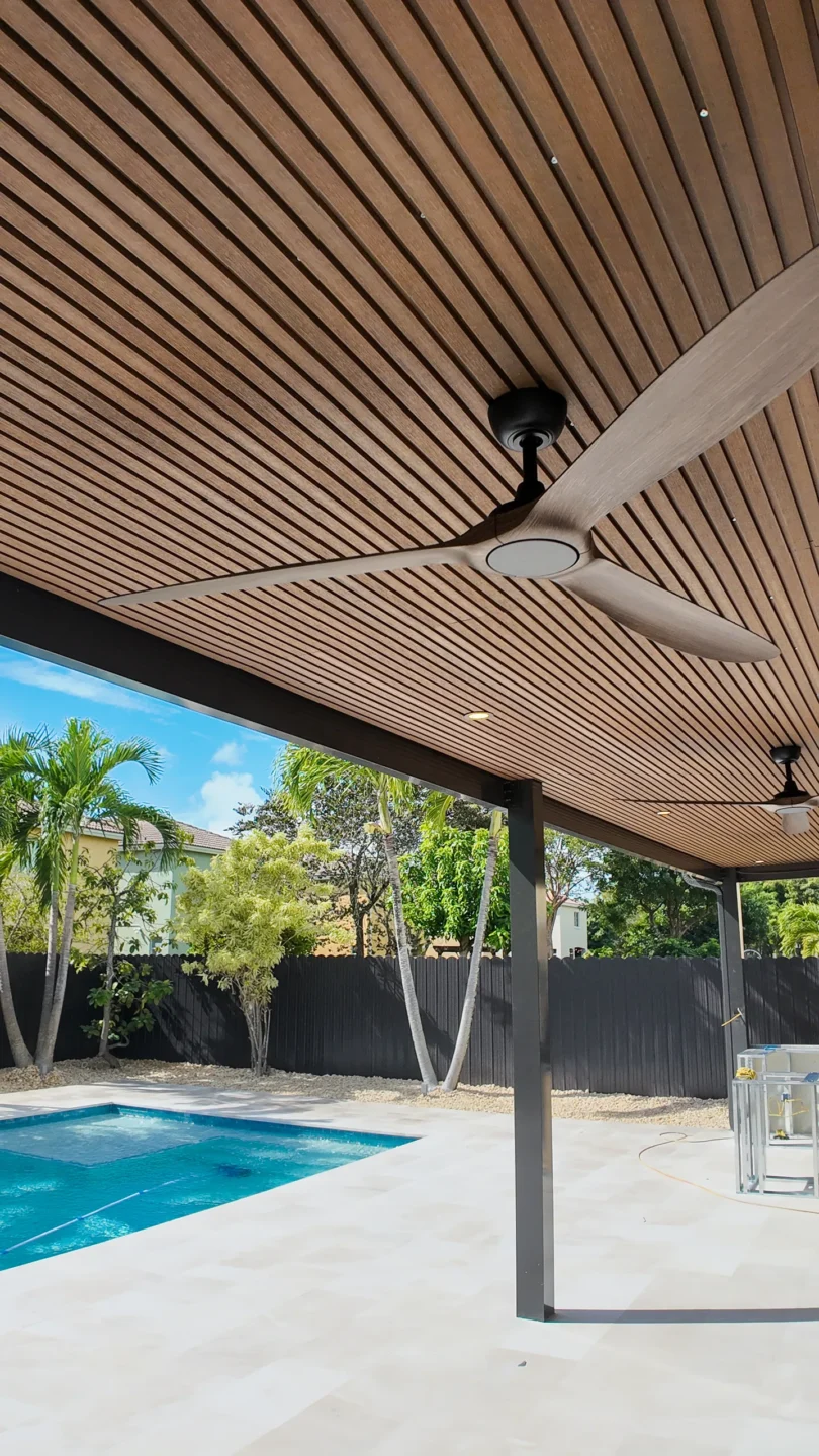 Covered patio addition with a wood-slat ceiling and ceiling fan