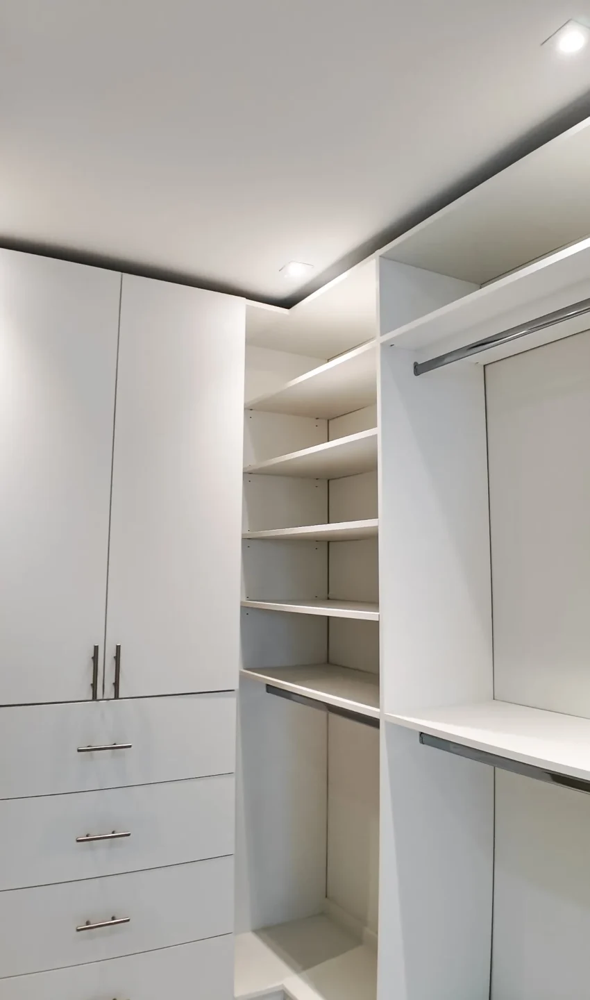 Custom walk-in closet with built-in cabinetry from a whole-home remodel