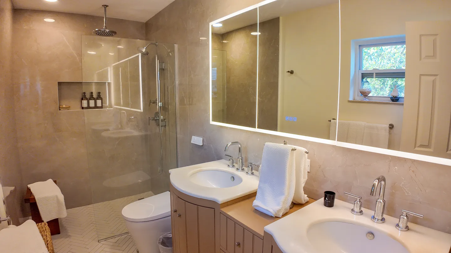 Double vanity with two sinks and a large mirror in a Miami bathroom remodel
