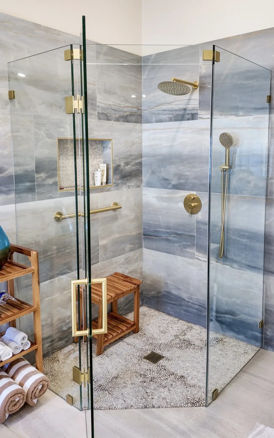 Frameless corner shower enclosure with glass hinges and minimal metal hardware