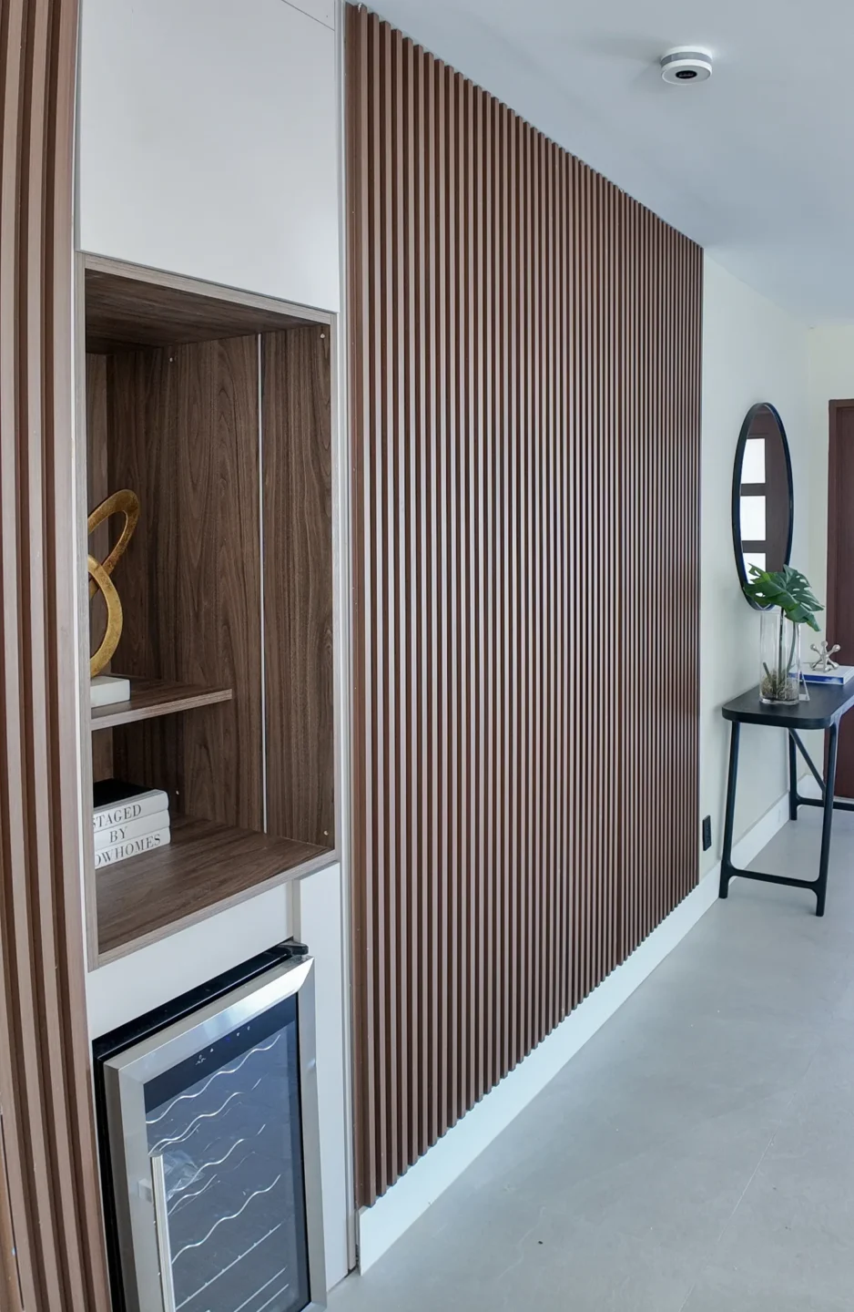 Finished family room with a wood feature wall and built-in cabinetry in a home addition