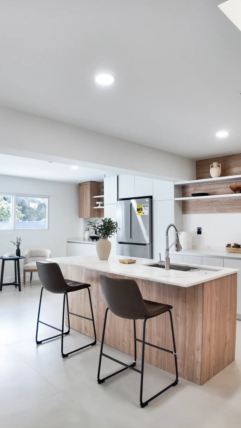 Modern Aventura kitchen with wood and white cabinets and a waterfall island