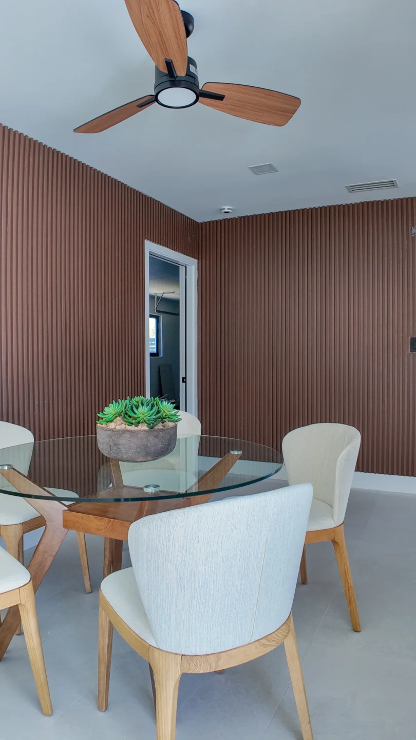 Open dining area with a wood slat accent wall in a South Florida interior remodel