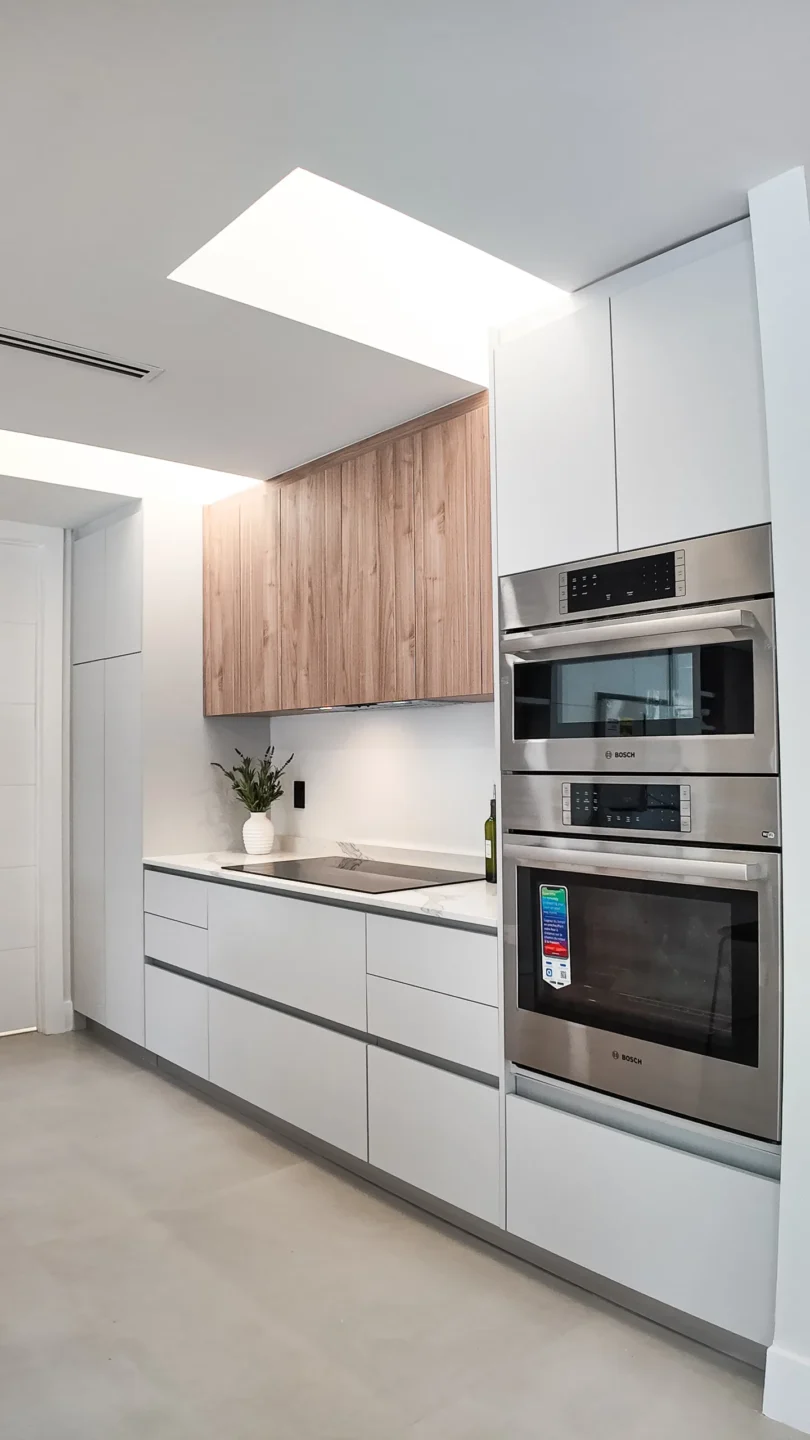 Tall kitchen cabinets with integrated wall ovens and finished end panels